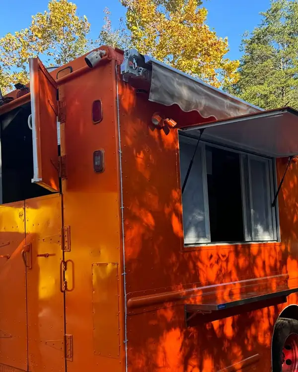 Taco Truck — orange truck with the service window and awning open