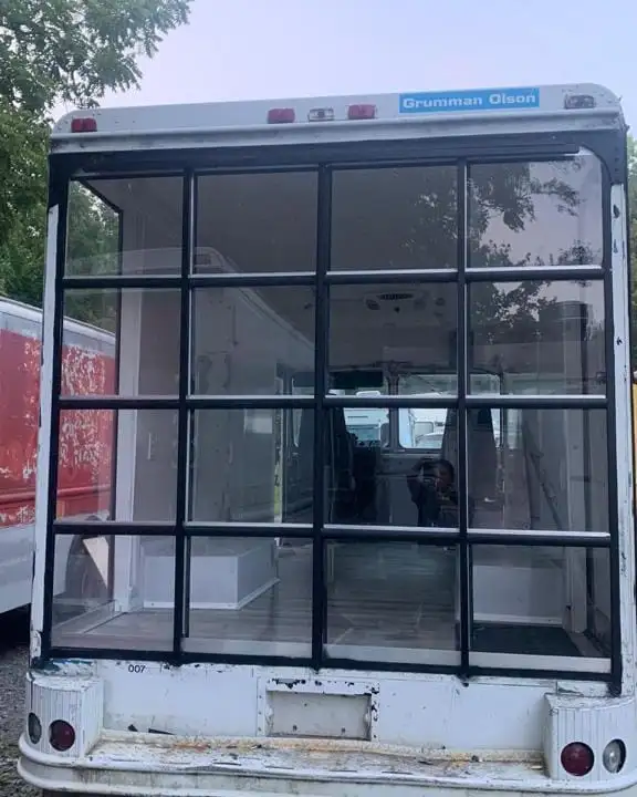 Mobile Boutique — glass storefront at the rear