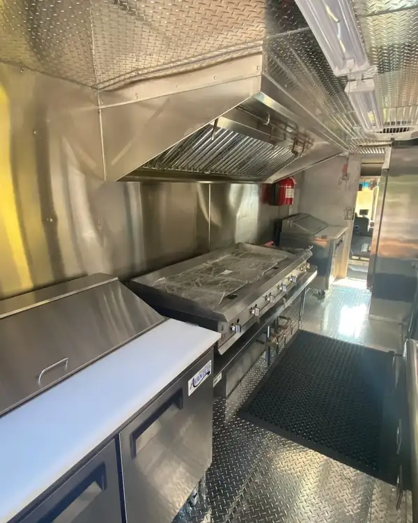 Tacos Los Primos — refrigerated prep table and griddle under the hood