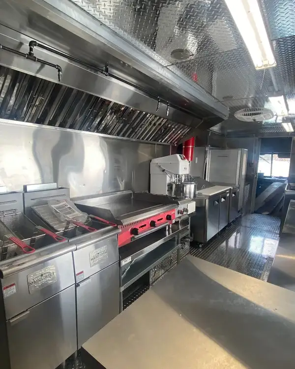 Double Kitchen — fryers and griddle at the cook line