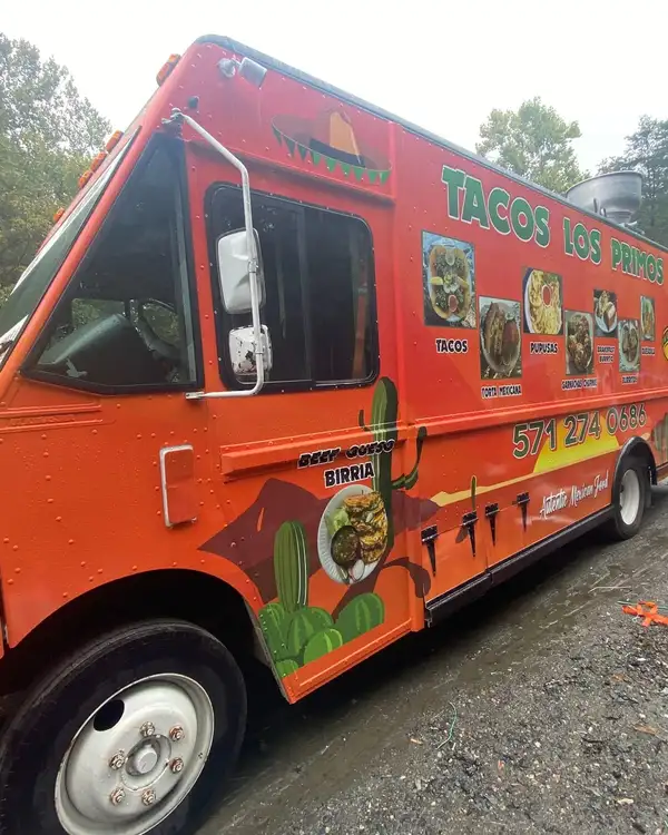 Tacos Los Primos — wrapped truck, front three-quarter view