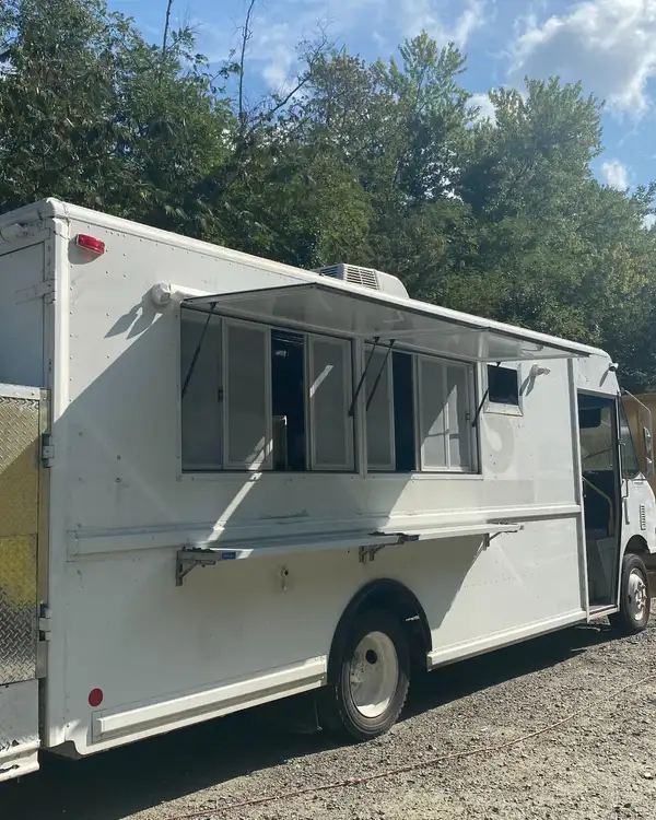 Tacos Los Primos — the white truck before the wrap