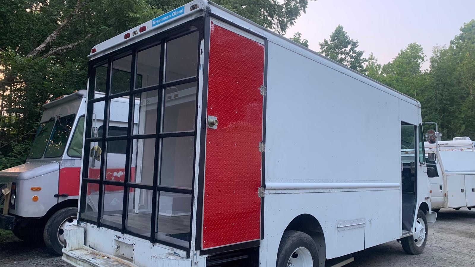 Mobile Boutique exterior with glass storefront and red door