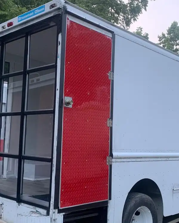 Mobile Boutique — glass storefront and red side door