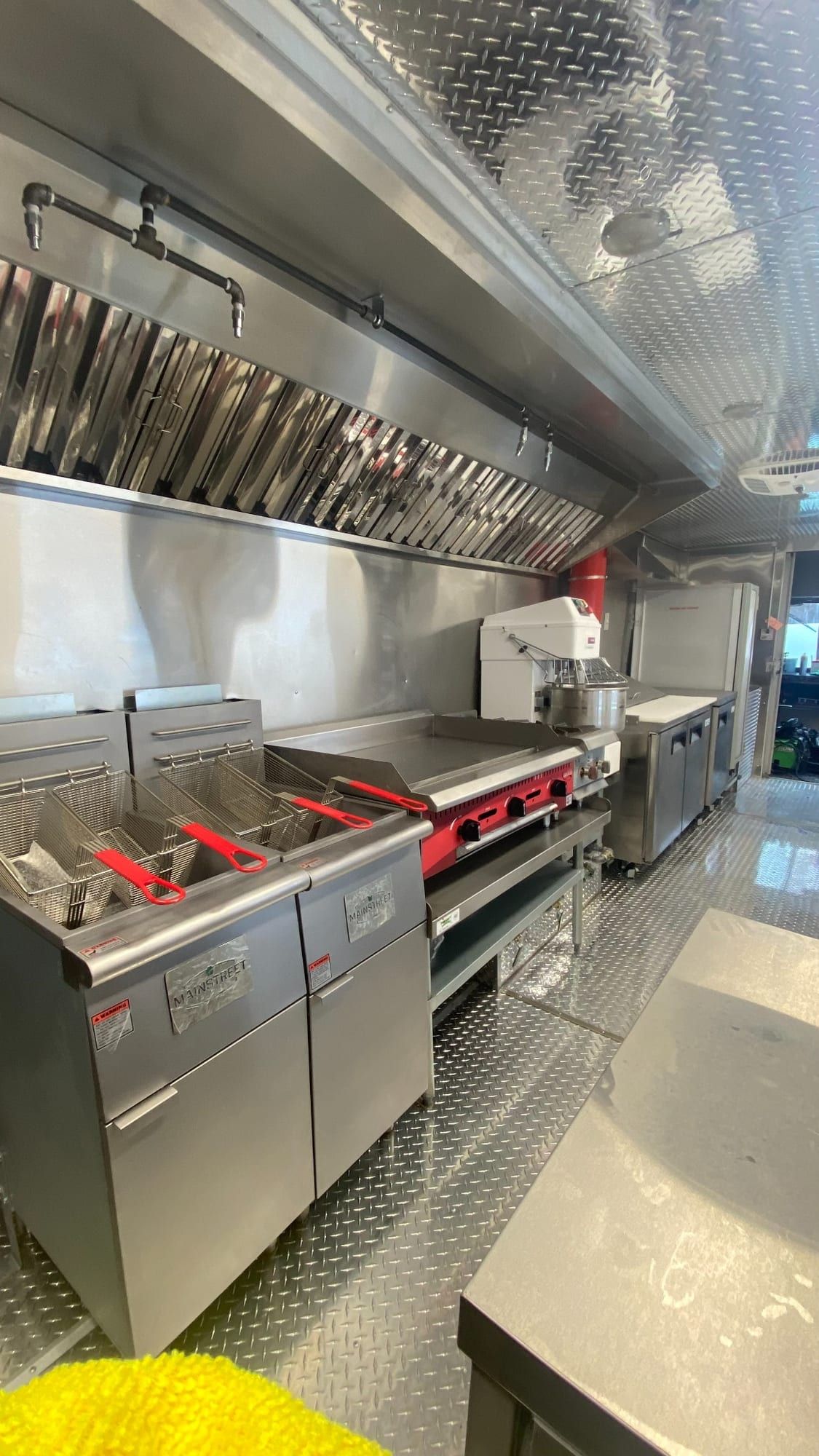 Fryers and griddle under the hood in the Double Kitchen