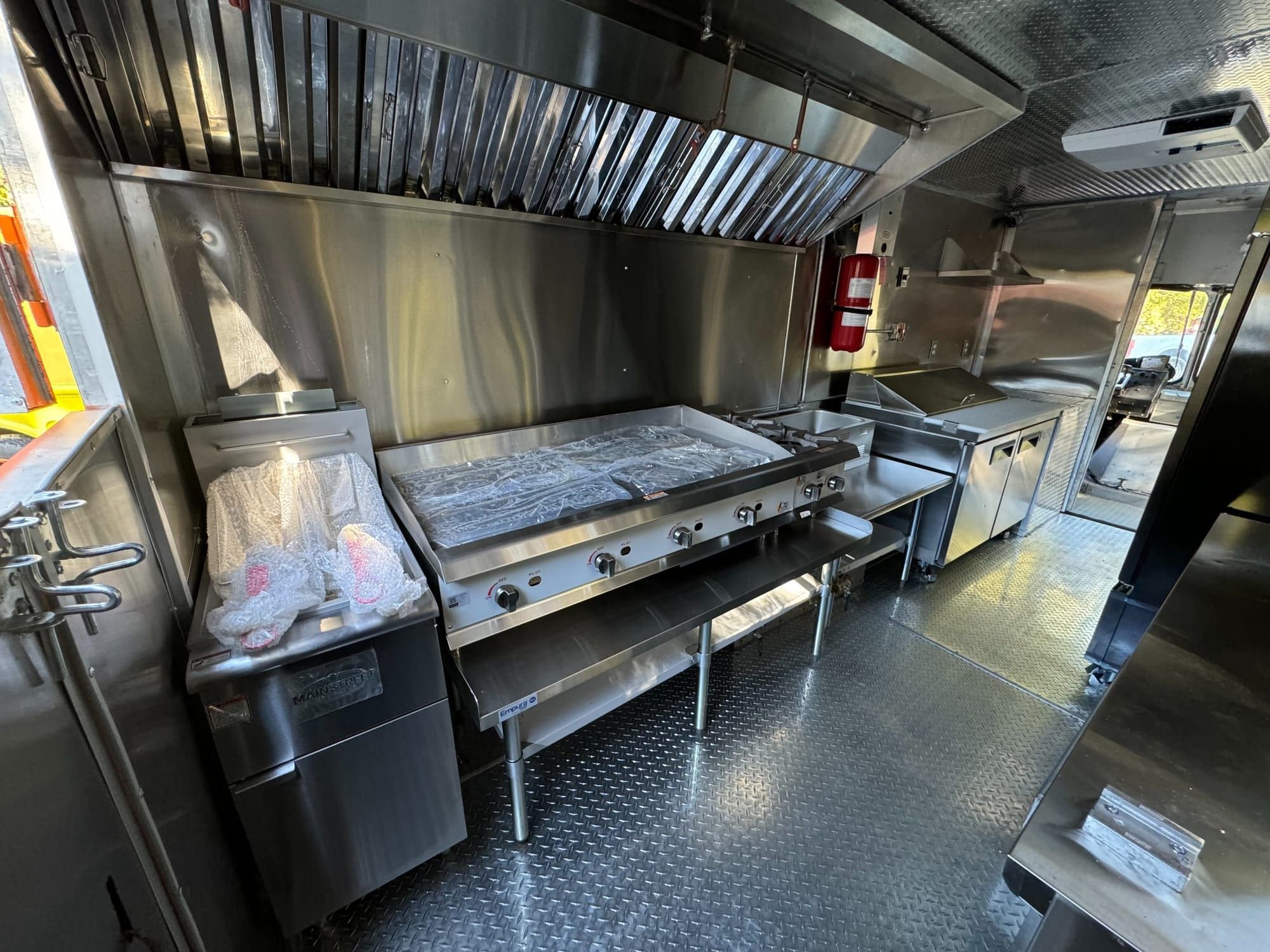 Griddle, hood and fryer inside the taco truck kitchen