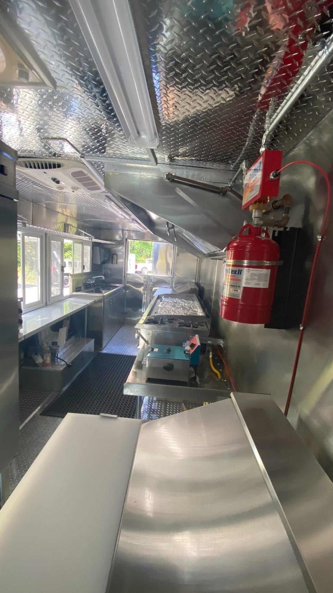 Tacos Los Primos kitchen with fire extinguisher, hood and stainless work areas
