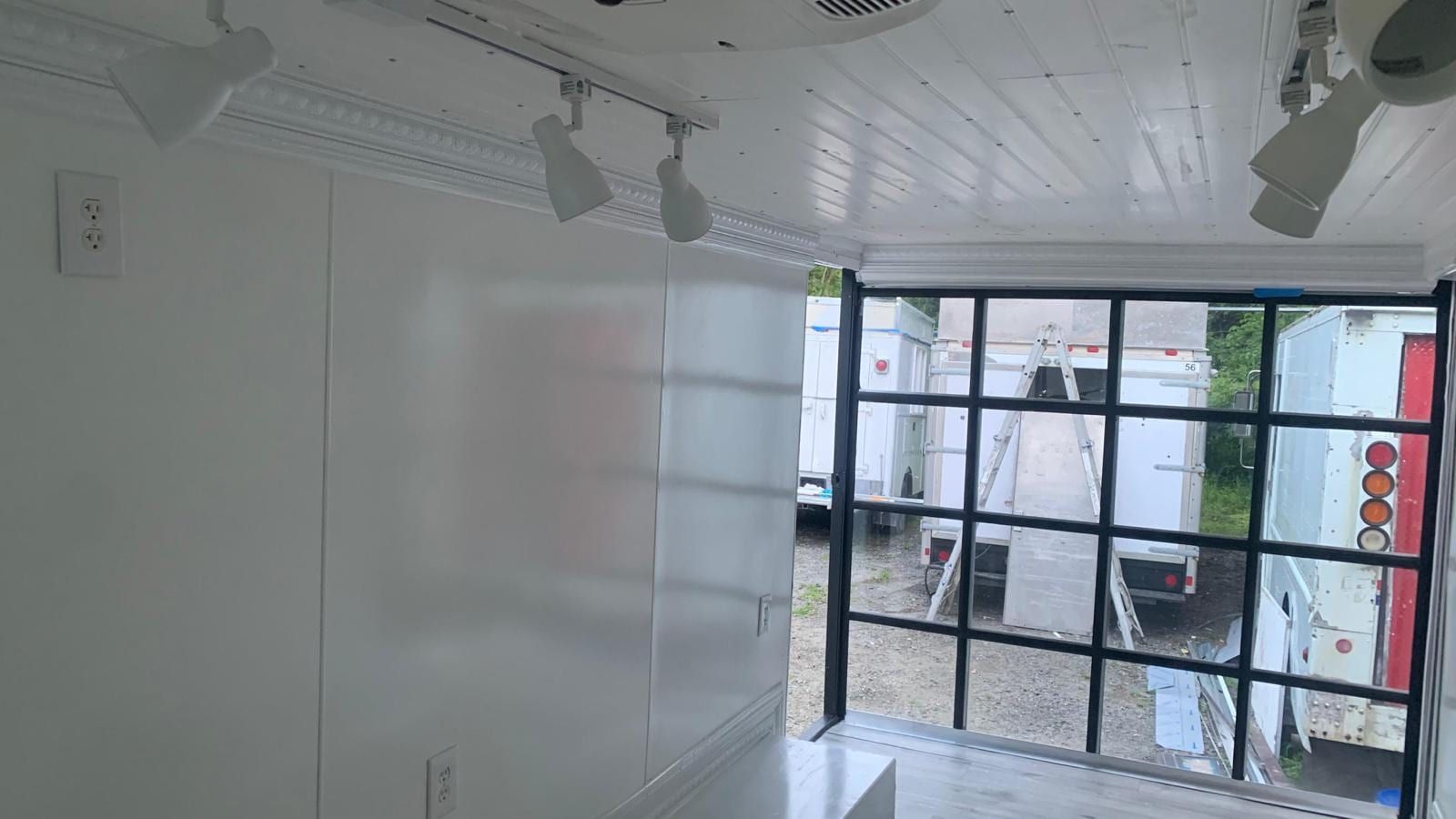 Retail floor with track lighting inside the Mobile Boutique
